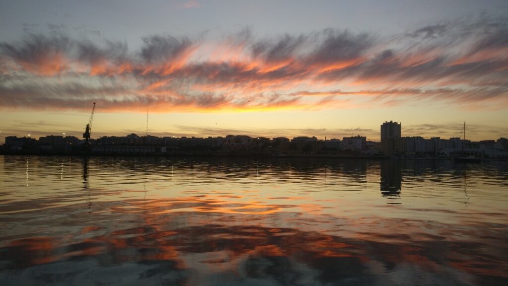 Beautiful sunset on the river of Portimão despite the industrial area